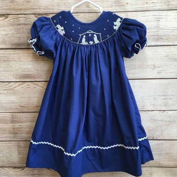 SMOCKED A LOT SMOCKED DRESS WITH EMBROIDERED NATIVITY SCENE - Picture 1 of 7